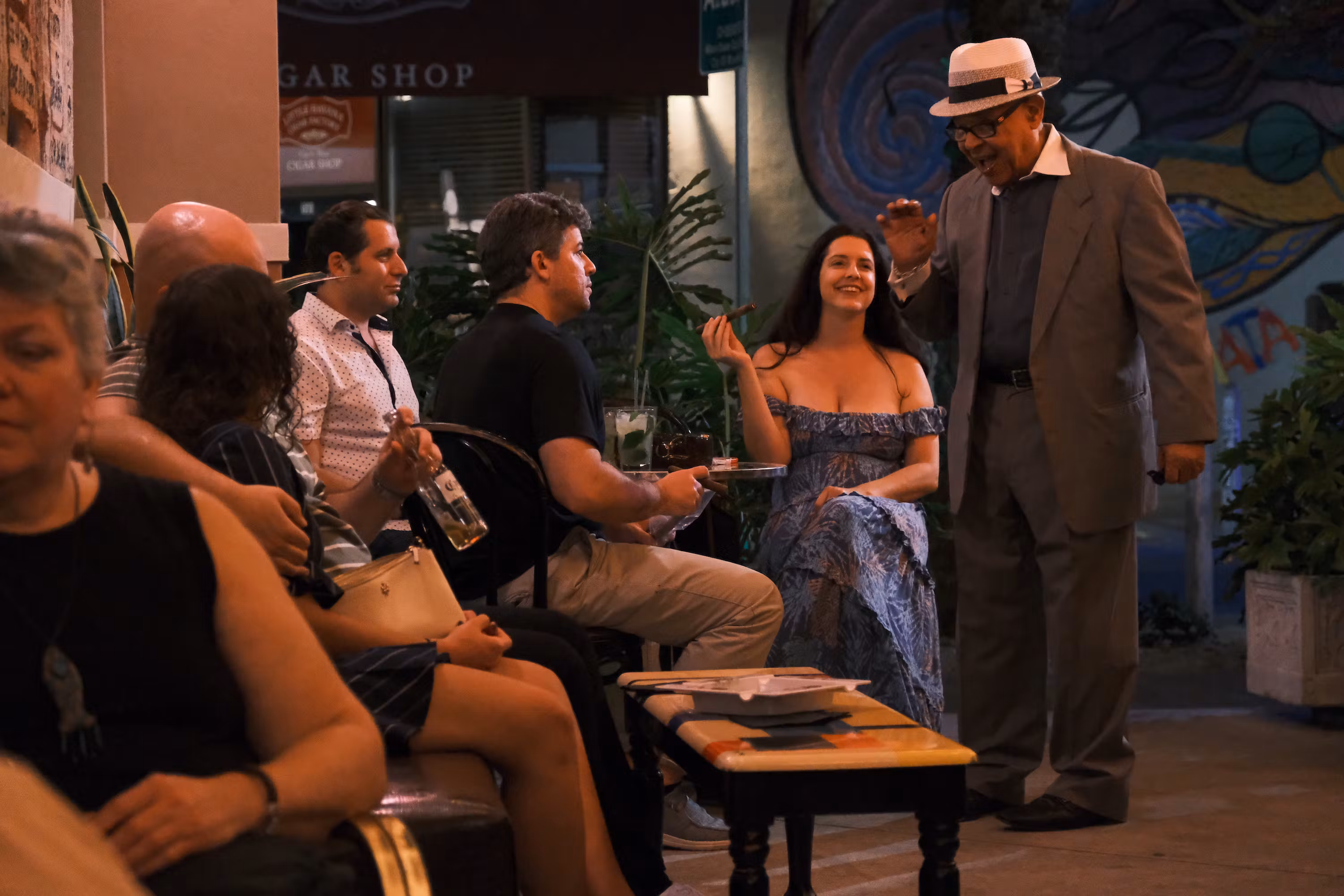 In Little Havana, the old man with the hat just lighted the woman's Cuban cigar